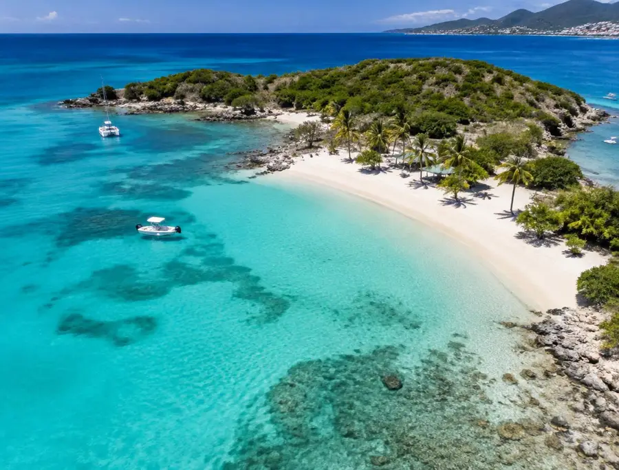 Turquoise bay and white sand beach of a small island off St Martin
